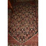 Hamadan rug with an all-over stylised lattice work Boteh and flower head design on a dark field