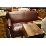 Modern burgundy leather upholstered two seater sofa by Wesley-Barrell