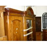 19th Century mahogany three door wardrobe having moulded arch top cornice with central mirrored