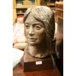 20th Century bust of a woman's head on wooden plinth