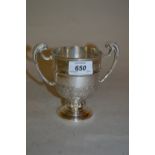 Small silver two handled pedestal trophy cup with chased acanthus leaf decoration,