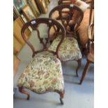 Pair of Victorian carved walnut balloon back side chairs with floral overstuffed seats and cabriole