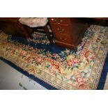 Chinese carpet with embossed floral design on a blue ground with borders,