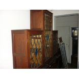 20th Century hardwood dwarf bookcase with leaded and coloured glass panelled doors
