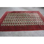 Indo Persian carpet of Tekke design with five rows of gols on a pale green ground with multiple