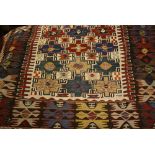 Caucasian Kelim rug with an all-over stylised design and multiple borders on an ivory ground,