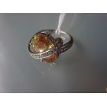 18ct White gold and diamond ring set with a central orange cubic zirconia