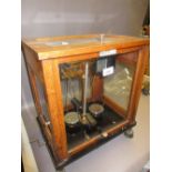 Pair of mahogany and glass cased laboratory scales