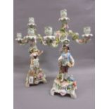 Pair of late 19th Century Continental porcelain four light candelabra with figural bases