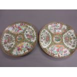 Pair of 19th Century Canton famille rose circular plates painted with panels of figures,
