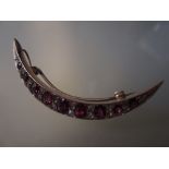 Victorian gold ruby and diamond set crescent brooch