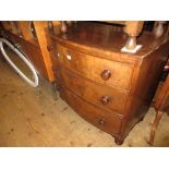 19th Century bow fronted chest of three long drawers with knob handles raised on turned supports