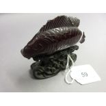 Chinese carved amber figure of a carp mounted on a hardwood base (a/f)