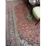 Modern Kashan carpet with a lobed medallion and all-over floral design on a pink ground with