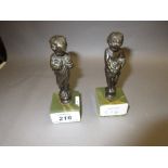 Pair of small patinated bronze figures of children on marble bases