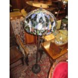 Tiffany style bronzed metal standard lamp with a large leaded coloured glass shade