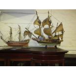 Painted wooden model of the Golden Hind together with a small wooden galleon model