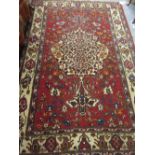 Baktiari rug with a lobed centre medallion and all-over stylised floral design on a red ground with