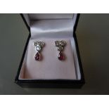 Pair of 18ct white gold diamond and pear shaped ruby drop earrings