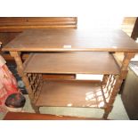 Early 20th Century oak three tier side table on turned supports with casters designed by Liberty