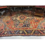 Heriz carpet, with large centre medallion and multiple borders (cut and worn),