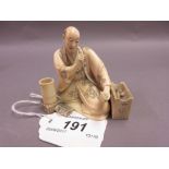 Japanese Meiji period carved ivory okimono, a seated man (minor damages),