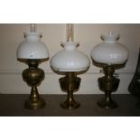 Early 20th Century embossed brass oil lamp with opaque glass shade and chimney together with two
