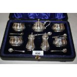 Edwardian Sheffield silver seven piece condiment set of embossed and engraved design in a fitted