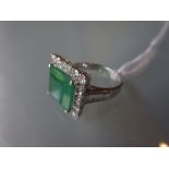 18ct White gold emerald and diamond square cluster ring with diamond set shoulders