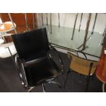 Modern glass and chrome table / desk together with a black leather swivel office chair