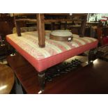 Large rectangular upholstered footstool on turned fluted tapering supports