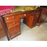 Victorian mahogany twin pedestal desk with a leather inset top above nine drawers on plinth bases