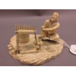 Japanese Meiji period carved ivory figure of a seated man beside a basket and other items (with