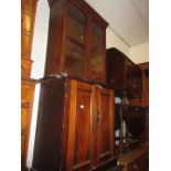 Victorian mahogany narrow bookcase, the moulded cornice above two glazed doors,