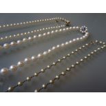 Uniform cultured pearl necklace with a 9ct gold blue zircon set clasp together with two simulated