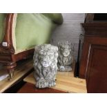 Pair of weathered cast concrete garden ornaments in the form of lions