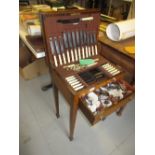 Oak cased twelve place setting canteen of plated cutlery in a floor standing cabinet,