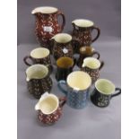 Graduated group of six Wetheriggs pottery jugs together with five similar mugs