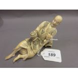 Japanese Meiji period carved ivory figure of a reclining man, startled by a snake (minor damages),