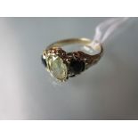 Citrine and tourmaline three stone ring set in yellow metal