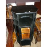 Edwardian ebonised pillar cabinet with an arrangement of open shelves and a single bevelled glass