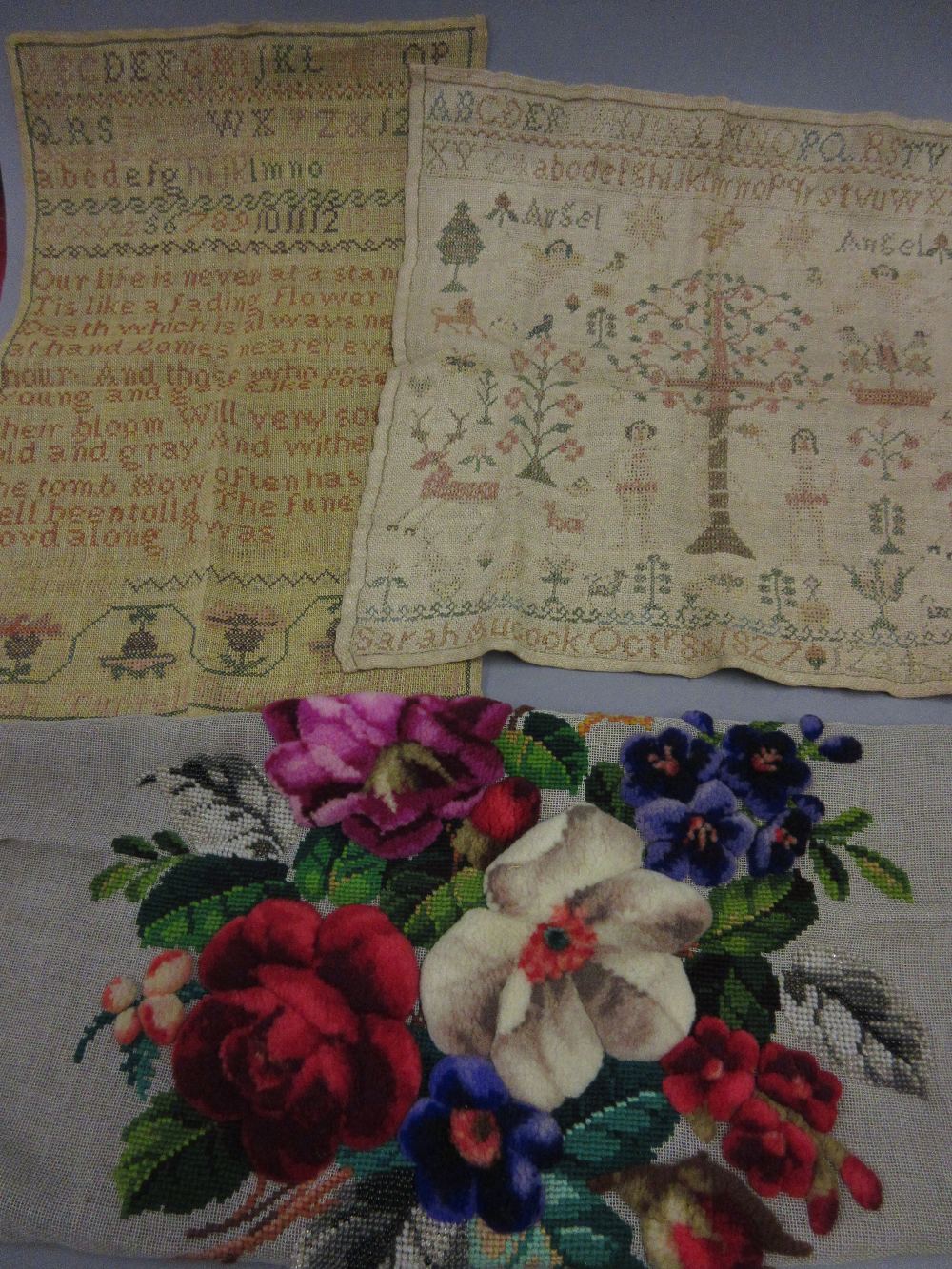 Two 19th Century unframed samplers together with a woolwork panel