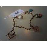 9ct Gold charm bracelet with four charms including Masonic garnet set dividers
