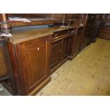 Victorian mahogany inverted breakfront sideboard with a centre drawer above two panelled doors