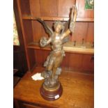 Large 19th Century French patinated spelter figure of a wind nymph holding a wreath on turned