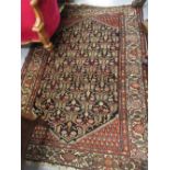 Hamadan rug with an all-over stylised lattice work Boteh and flower head design on a dark field