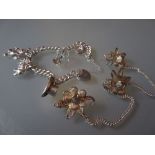 Silver charm bracelet and a brooch