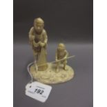 Japanese Meiji period carved ivory okimono group of father and son with fishing net and rod (minor