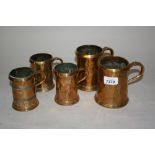 Five various Georgian brass mounted copper mugs