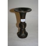 Chinese dark patinated bronze flared rim vase with traces of gilding